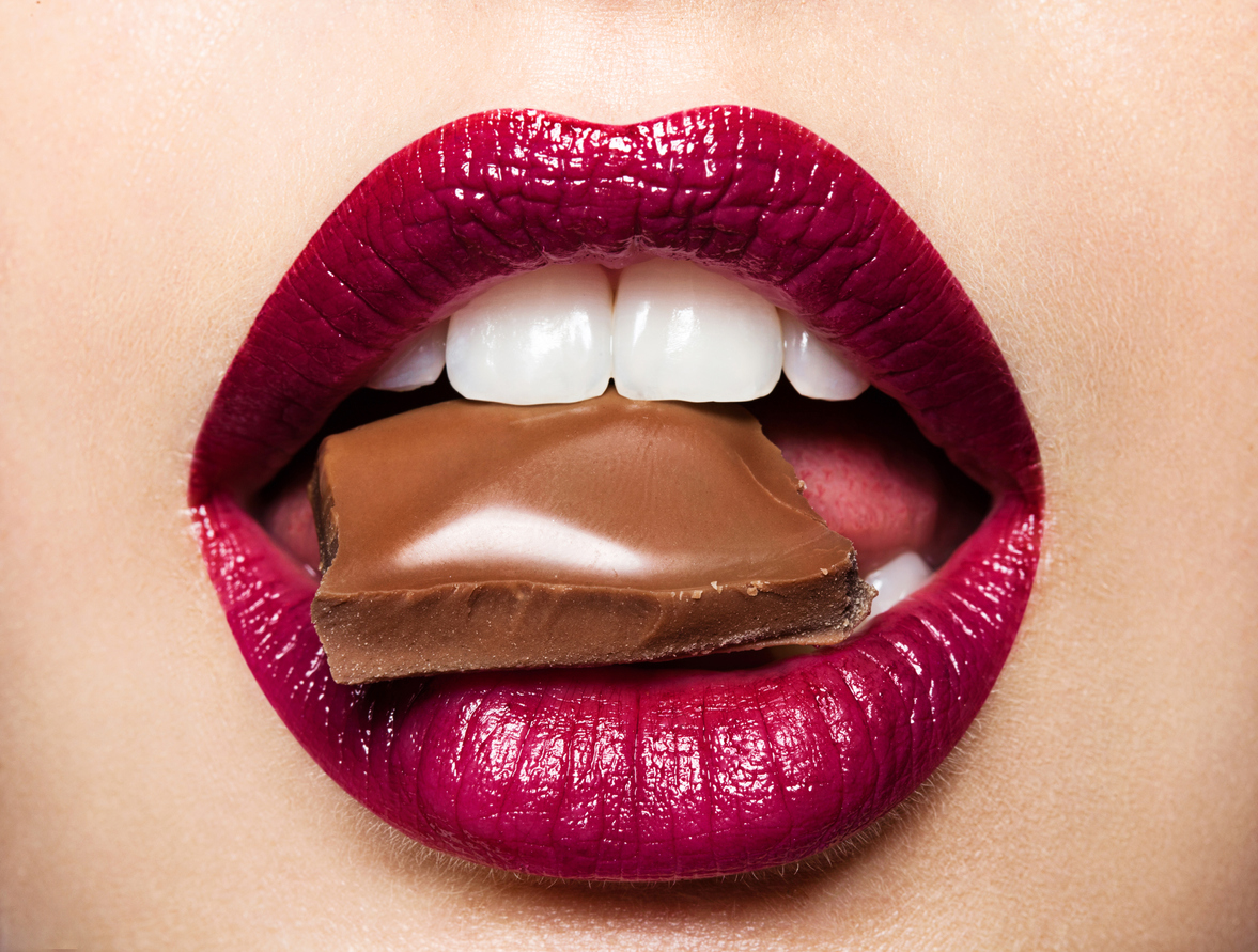 Beautiful female lips with chocolate